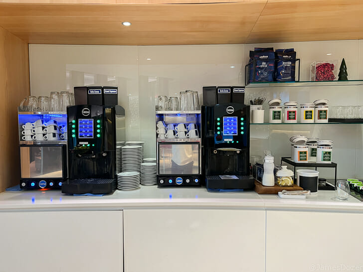 a coffee machine and cups on a counter