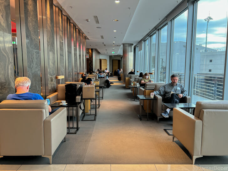 people sitting in a room with many chairs and tables