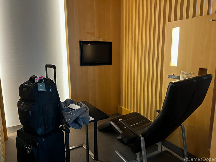 a room with a chair and a suitcase