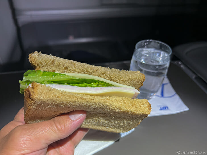a hand holding a sandwich