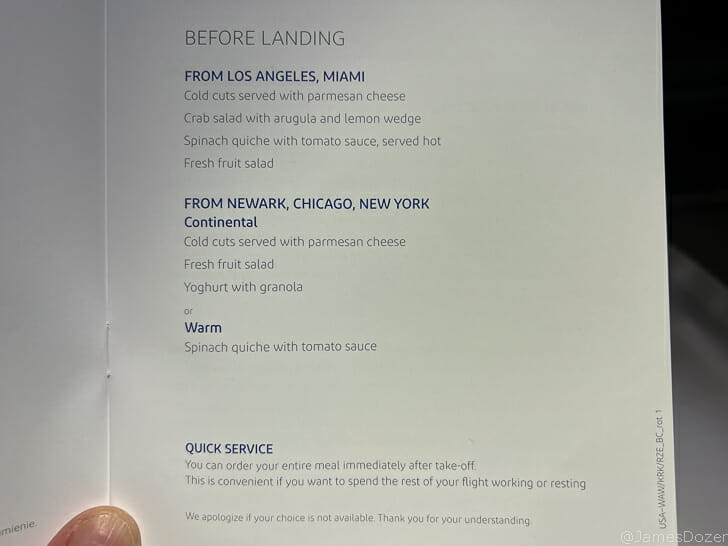 a hand holding a menu