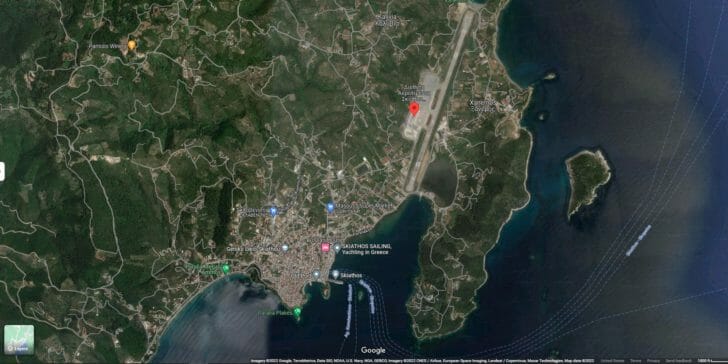 a map of land with a runway and buildings