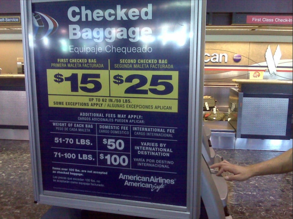 a hand pressing a check-in machine