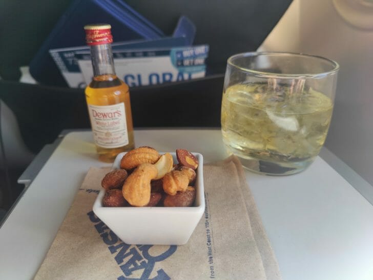 a bowl of nuts and a glass of liquid