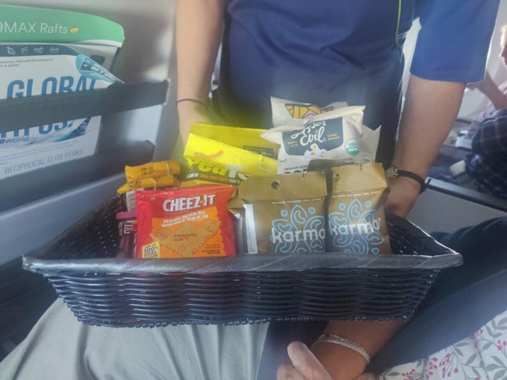 a person holding a basket of snacks