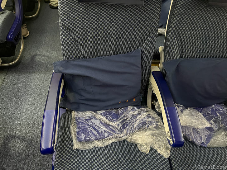 a seat with a pillow and a plastic bag