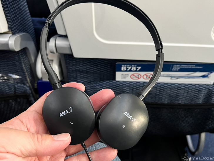 a hand holding headphones
