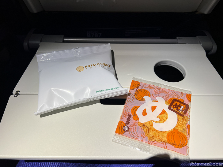 a white packet and orange packet on a white surface