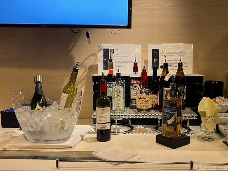 a group of bottles of alcohol on a bar