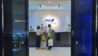 a group of people standing in front of a desk