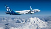 a plane flying over a snowy mountain