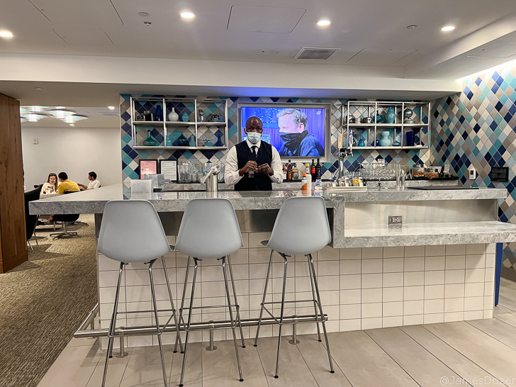 a man wearing a face mask at a bar