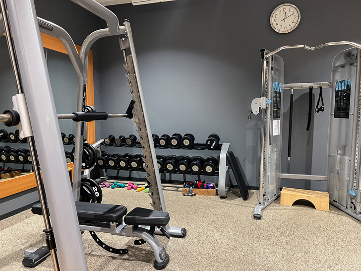 a gym with weights and a clock
