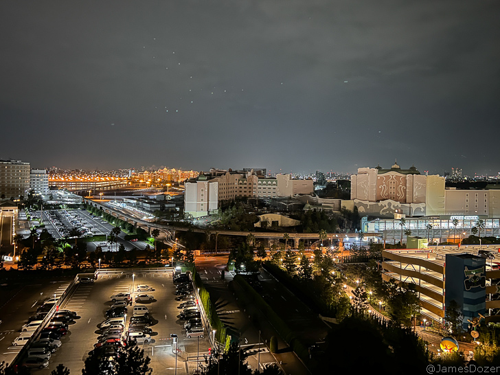 a city at night with cars and buildings