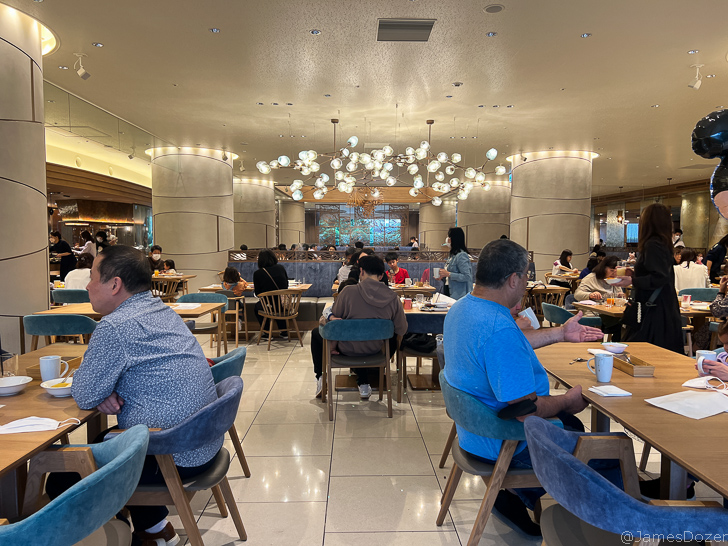 a group of people sitting at tables in a restaurant