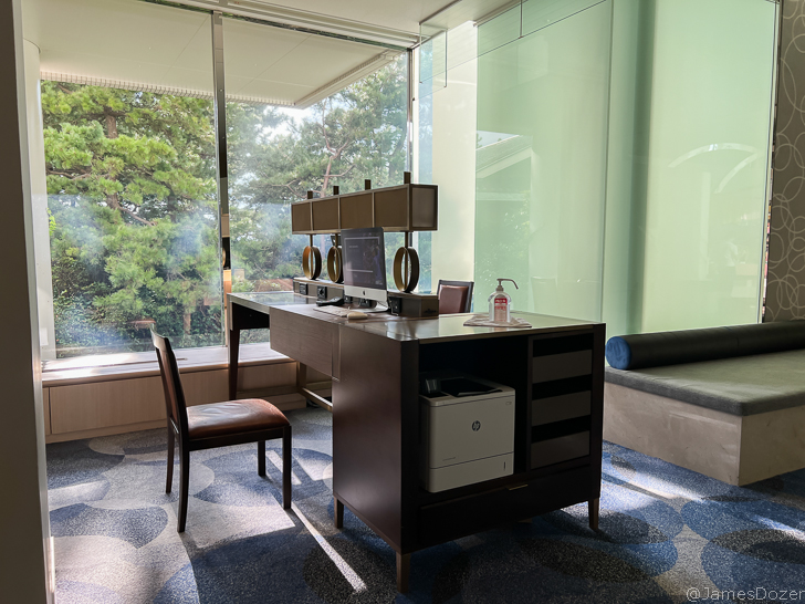 a desk with a chair and a window
