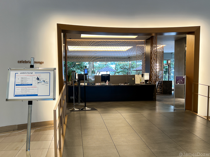 a lobby with a sign and a bar