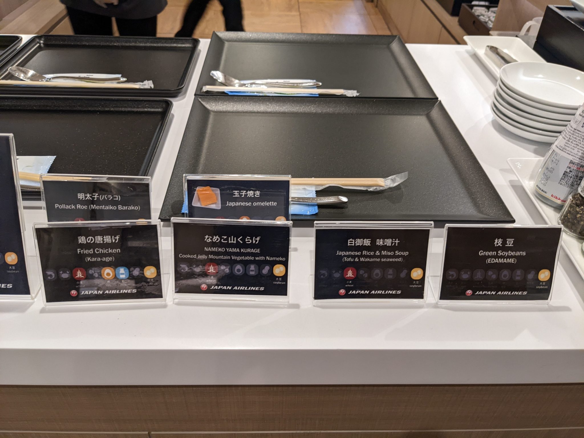 plates on a counter with plates and utensils