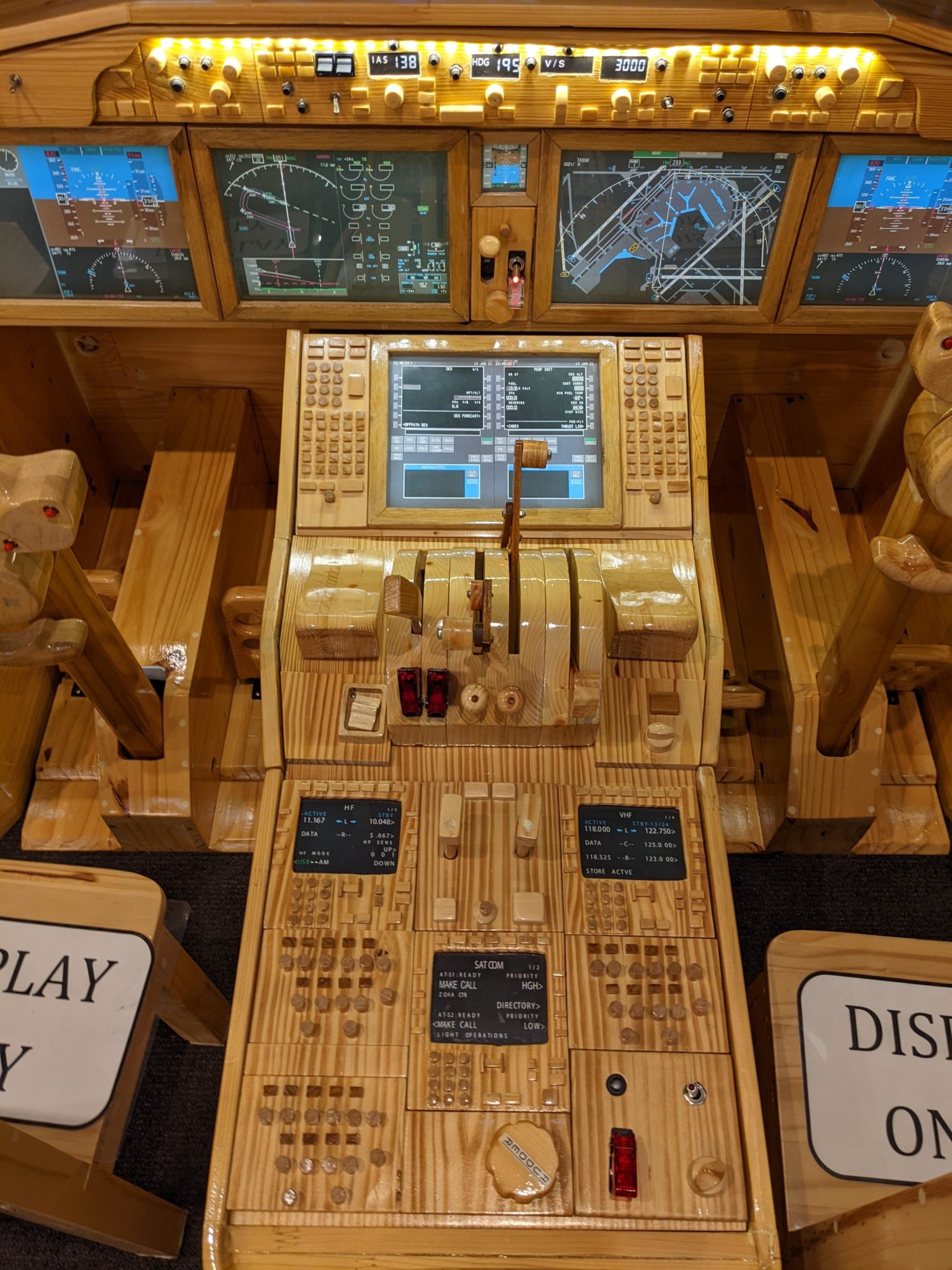 a wooden control panel with multiple screens