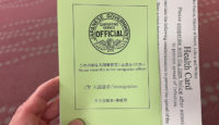 a hand holding a green card