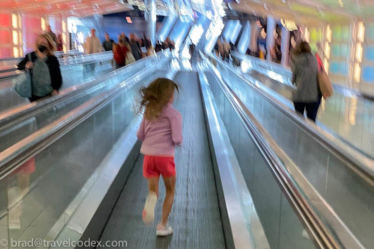 a girl running on an escalator