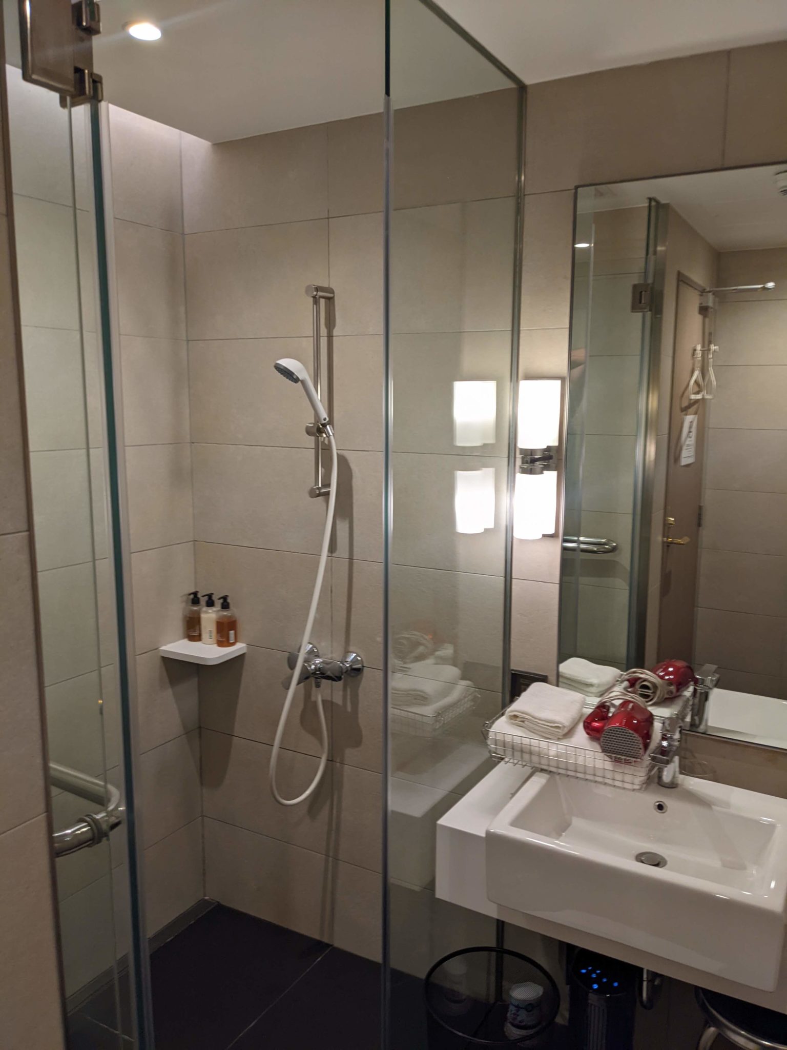 a bathroom with a shower and sink