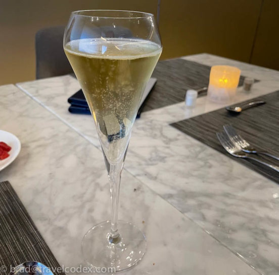 a glass of champagne on a table