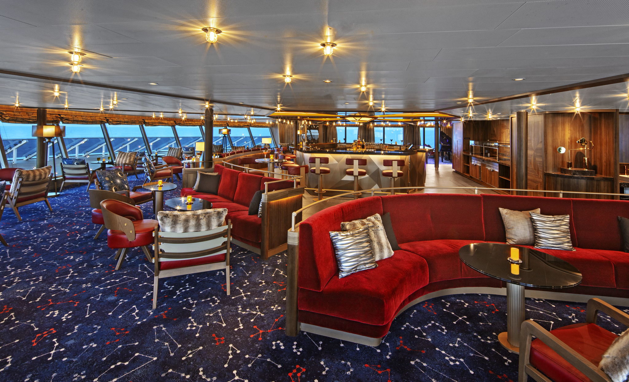 a room with red couches and tables
