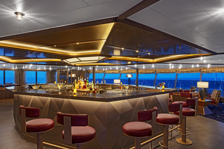a bar with a counter and chairs