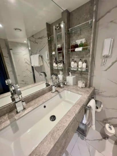 a bathroom with a marble countertop and a sink