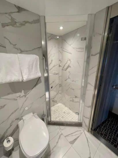 a bathroom with a glass shower door