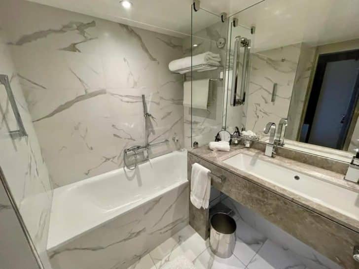 a bathroom with marble walls and a sink