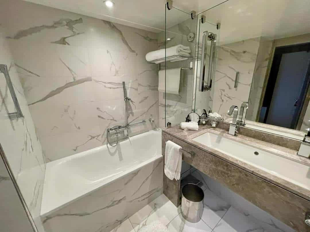 a bathroom with marble walls and a tub