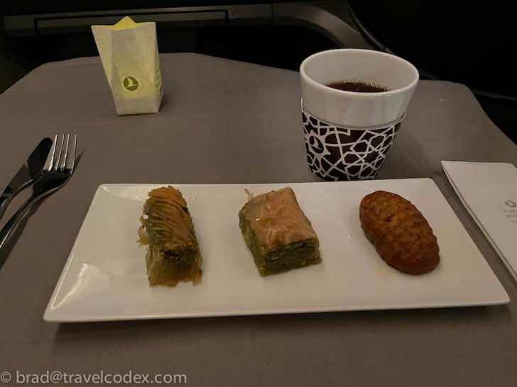 a plate of food and a cup of coffee on a table