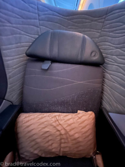 a seat with a pillow and a pillow on it