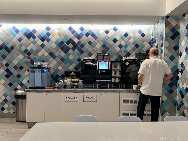 a man standing in a room with a coffee machine
