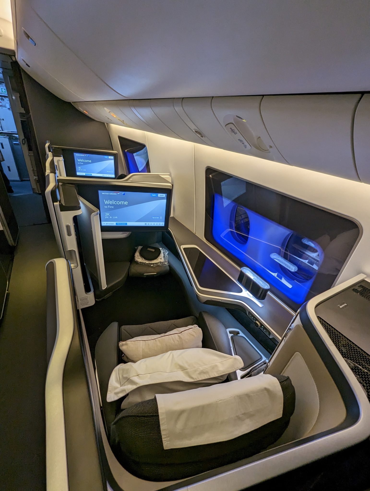 a seat with a monitor and a tv on the back of the seat