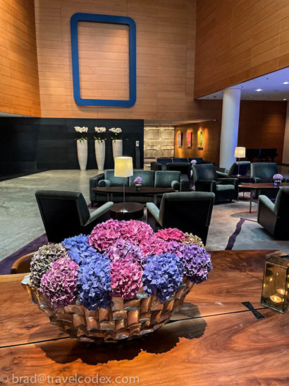 a room with a large glass bowl of flowers