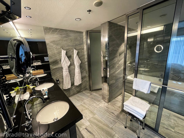a bathroom with two sinks and a shower