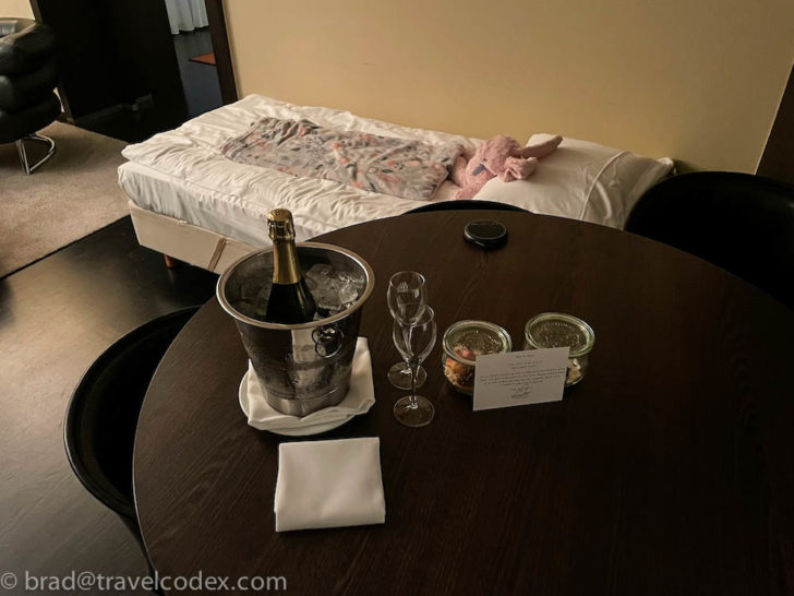 a table with a bottle of champagne and two glasses on it