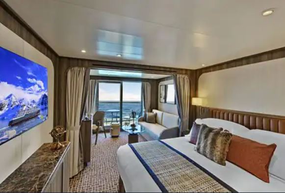 a room with a bed and a television