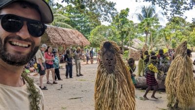a man taking a selfie with people in the background