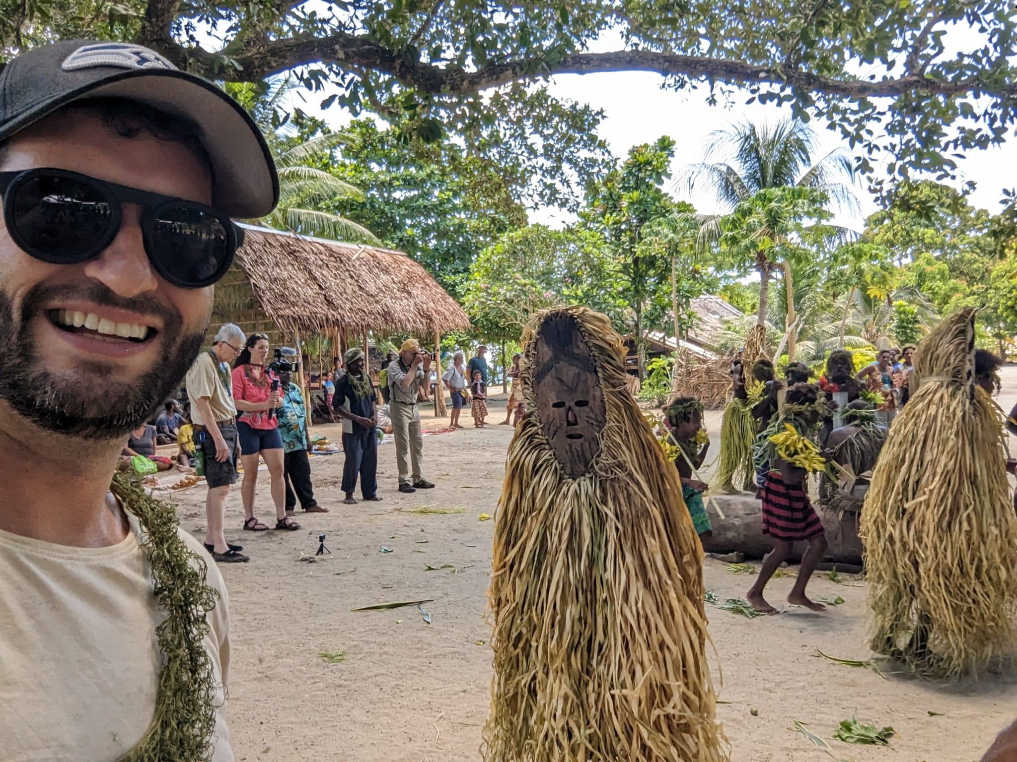 a man taking a selfie with people in the background