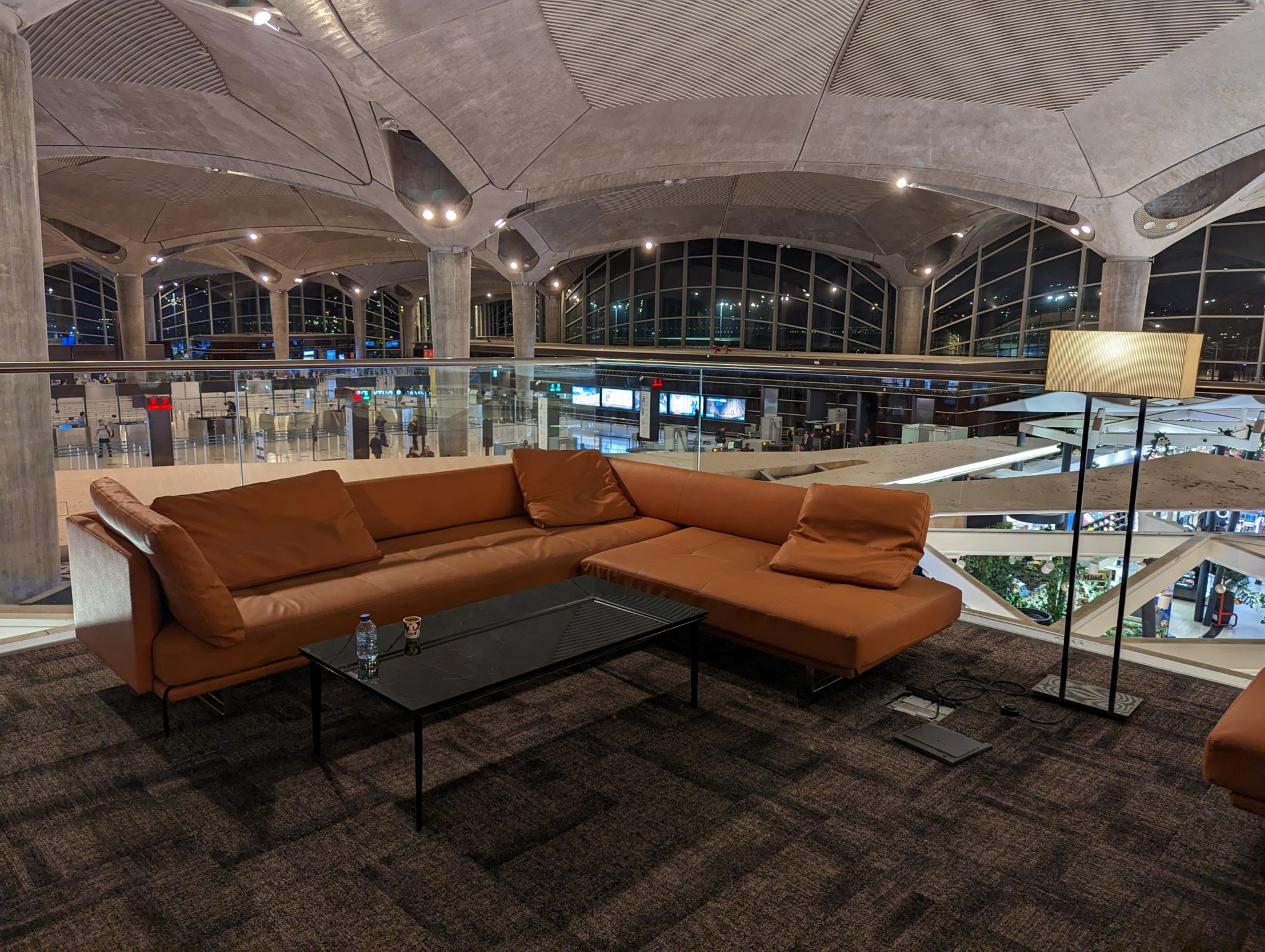a couch and coffee table in a room with glass walls
