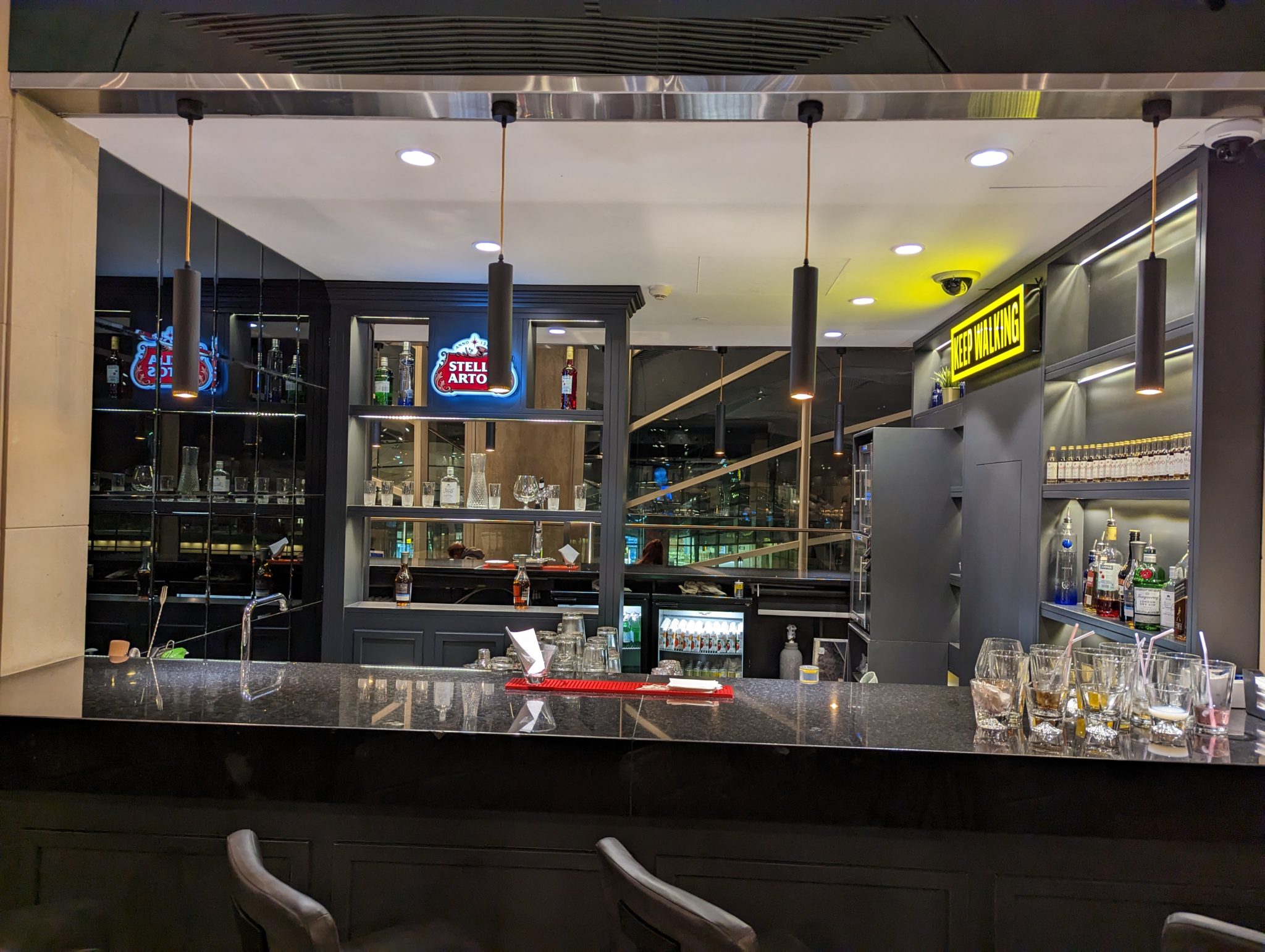 a bar with glasses and bottles