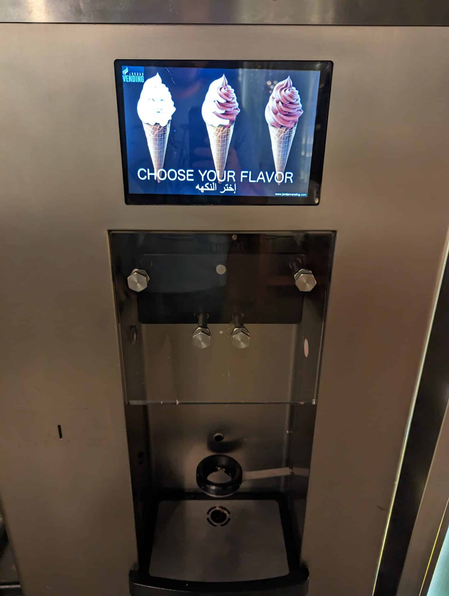 a machine with a screen and a picture of ice cream cones