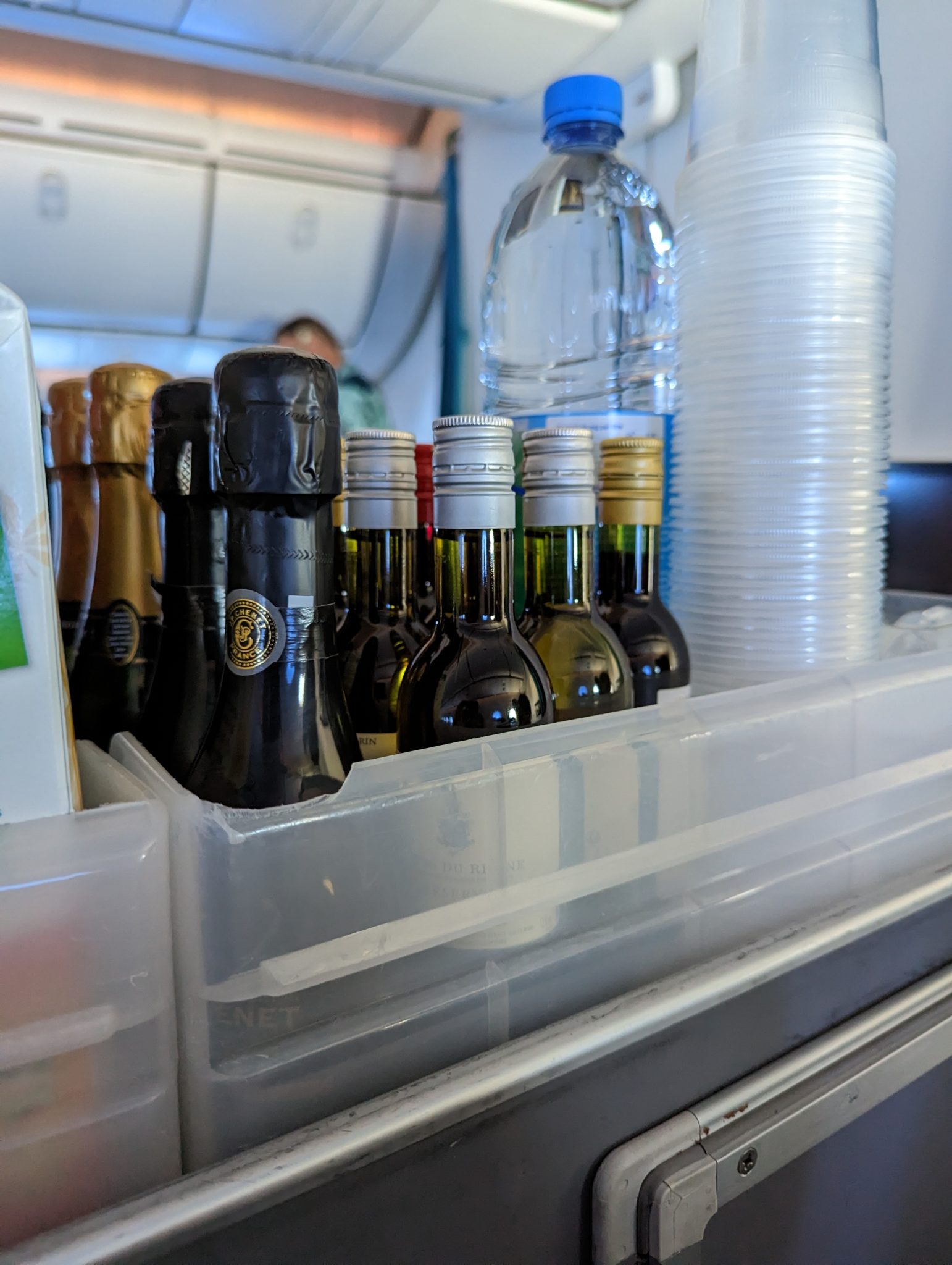 a group of bottles and cups in a container