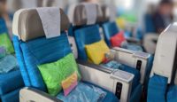 a row of blue chairs with pillows