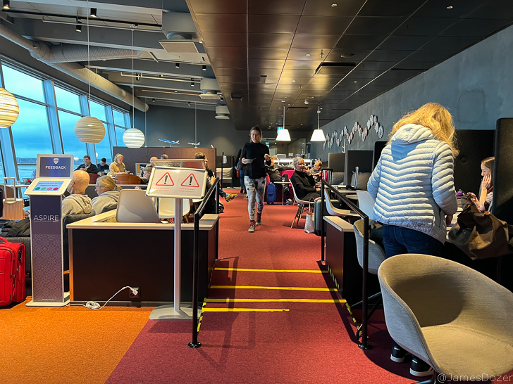 a group of people in a room with chairs and tables