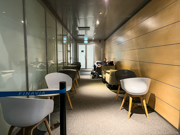 a man sitting on a chair in a hallway